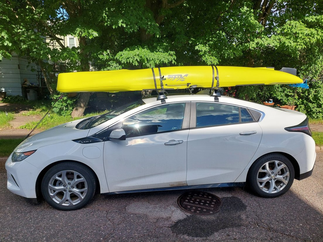 A kayak strapped to the roof of a car